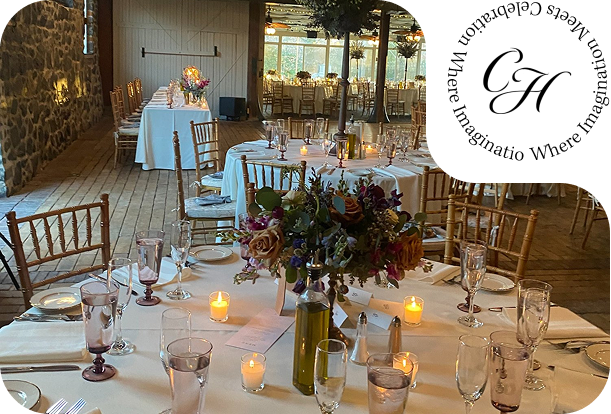 Wedding reception setup inside the Rockwood Carriage House with floral centerpieces, candlelight, and gold chairs