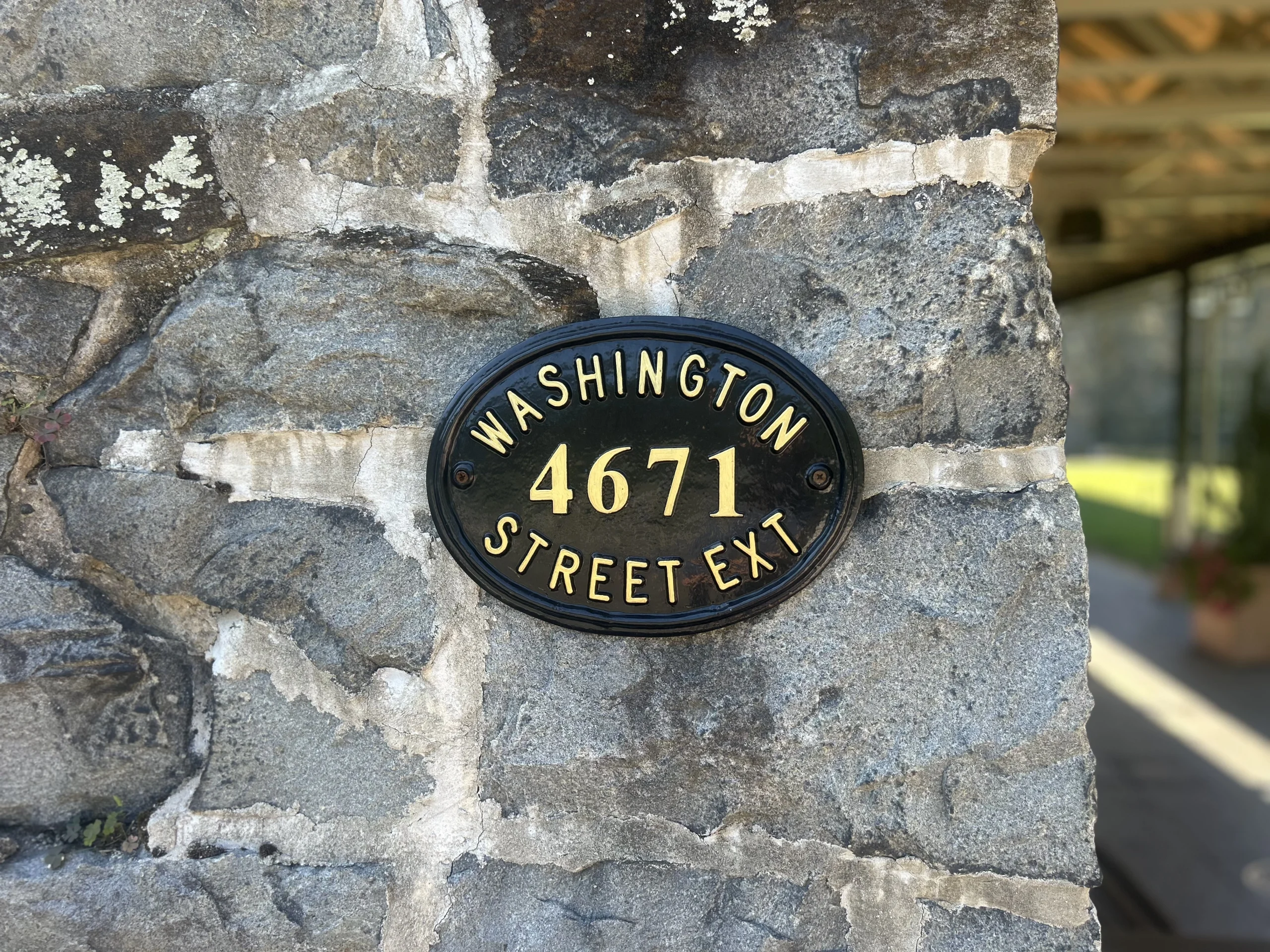 4671 Washington Street Extension address plaque on the stone exterior of Rockwood Carriage House